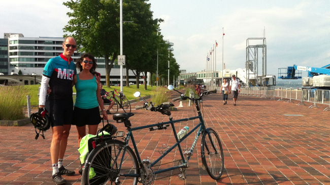 Couple standing by their tandem bike in Quebec city