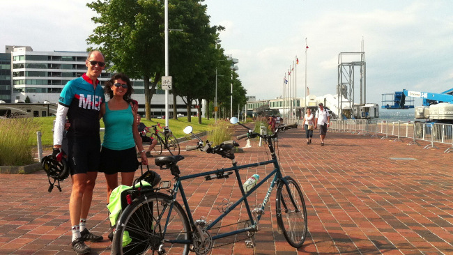 Couple standing by their tandem bike in Quebec city